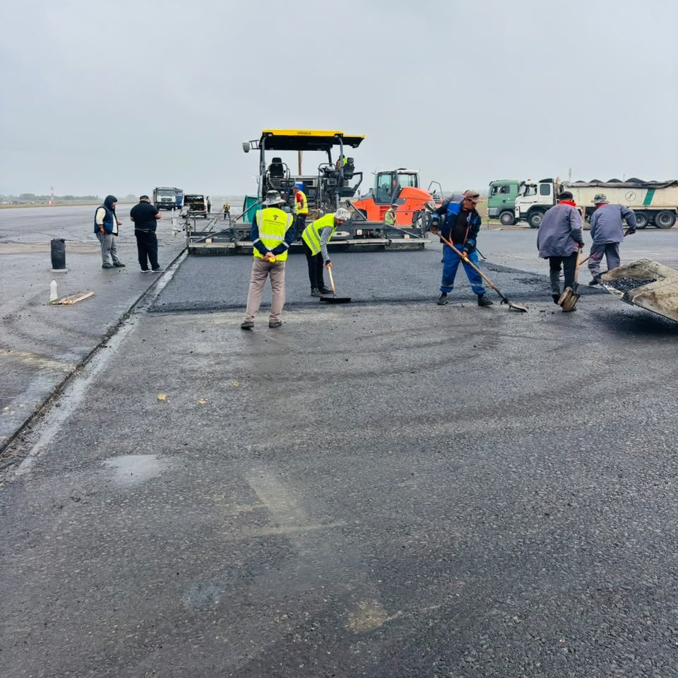 Paving crew at work during rain